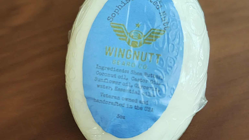 Raw Nutt unscented solid beard shampoo puck on dark workshop slate