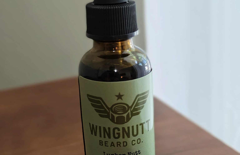 Lumber Nutt cedarwood scented beard oil on raw wood timber