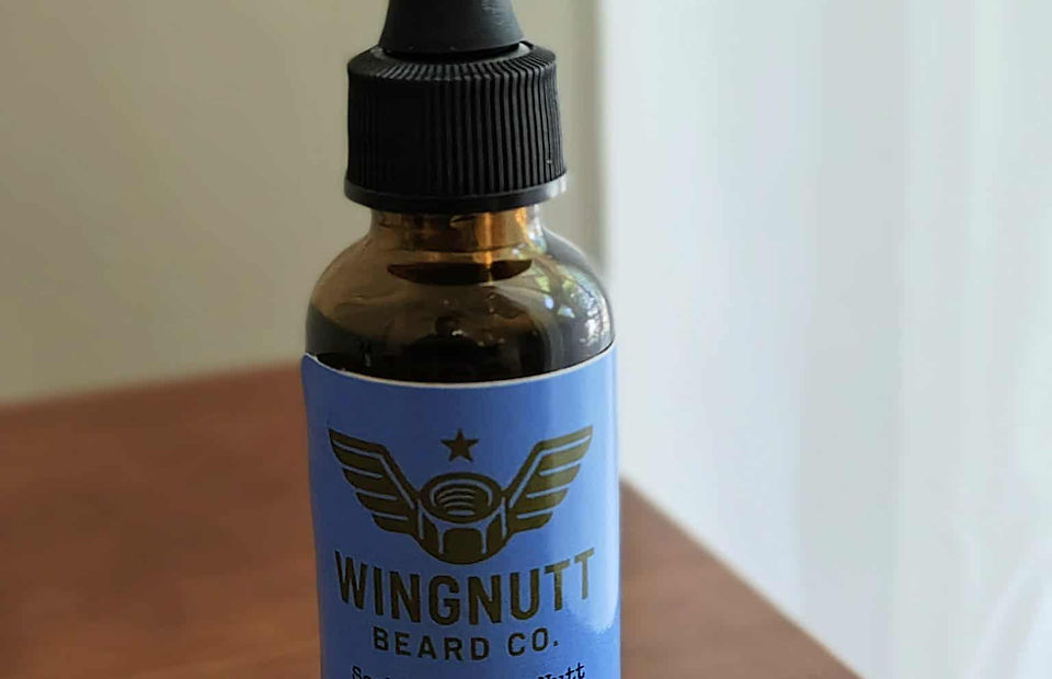 Sophisticated Nutt premium beard oil bottle in handcrafted workshop