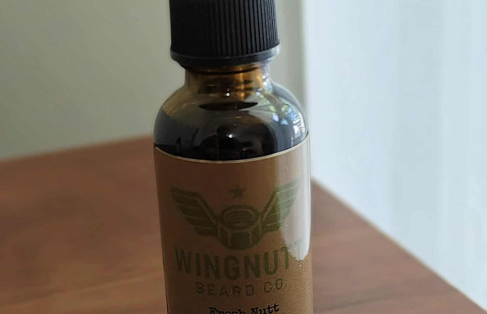 Fresh Nutt cool mint beard oil bottle on rugged stone surface